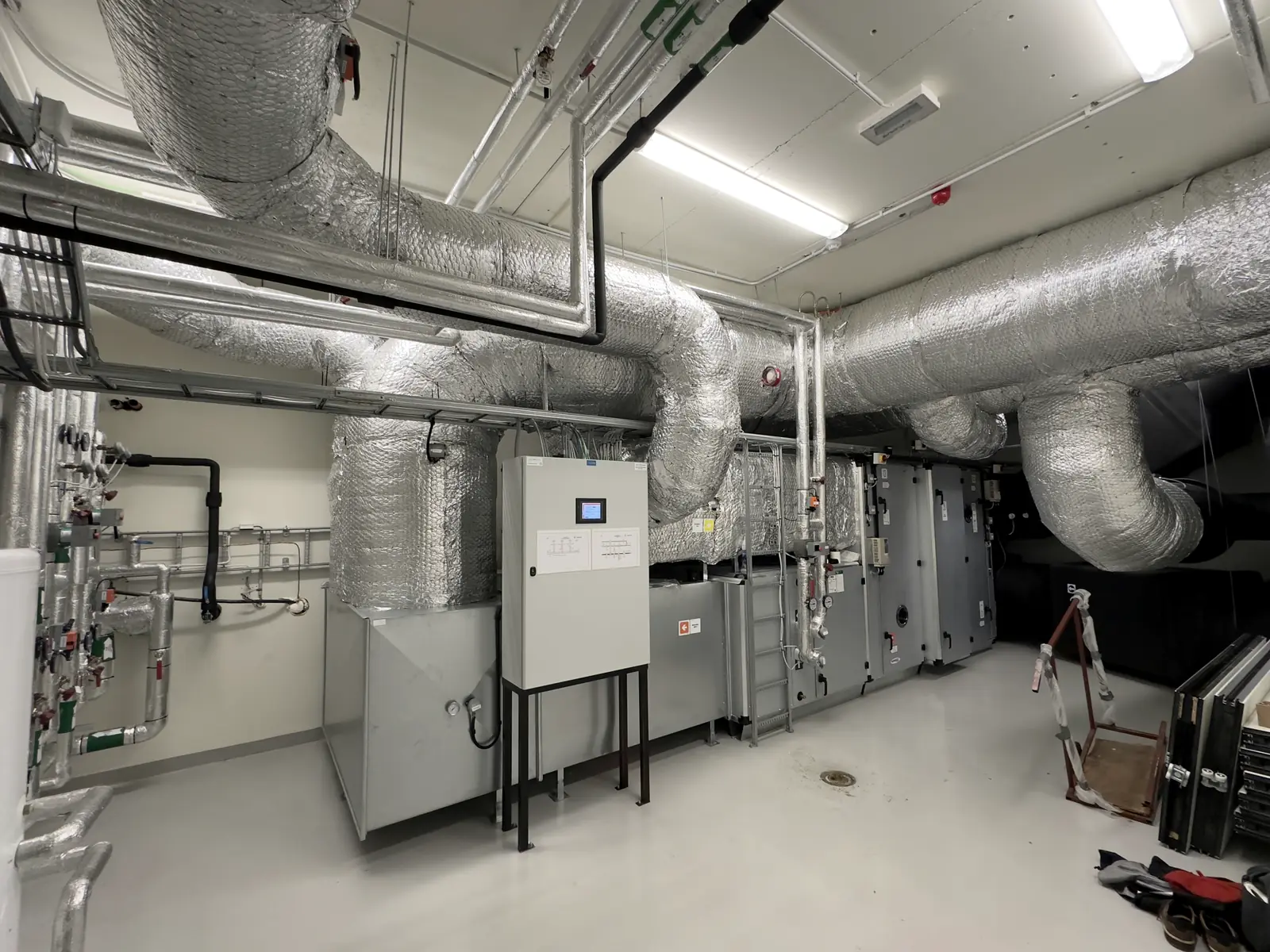 Mechanical plant room with ductwork, pumps and control panels
