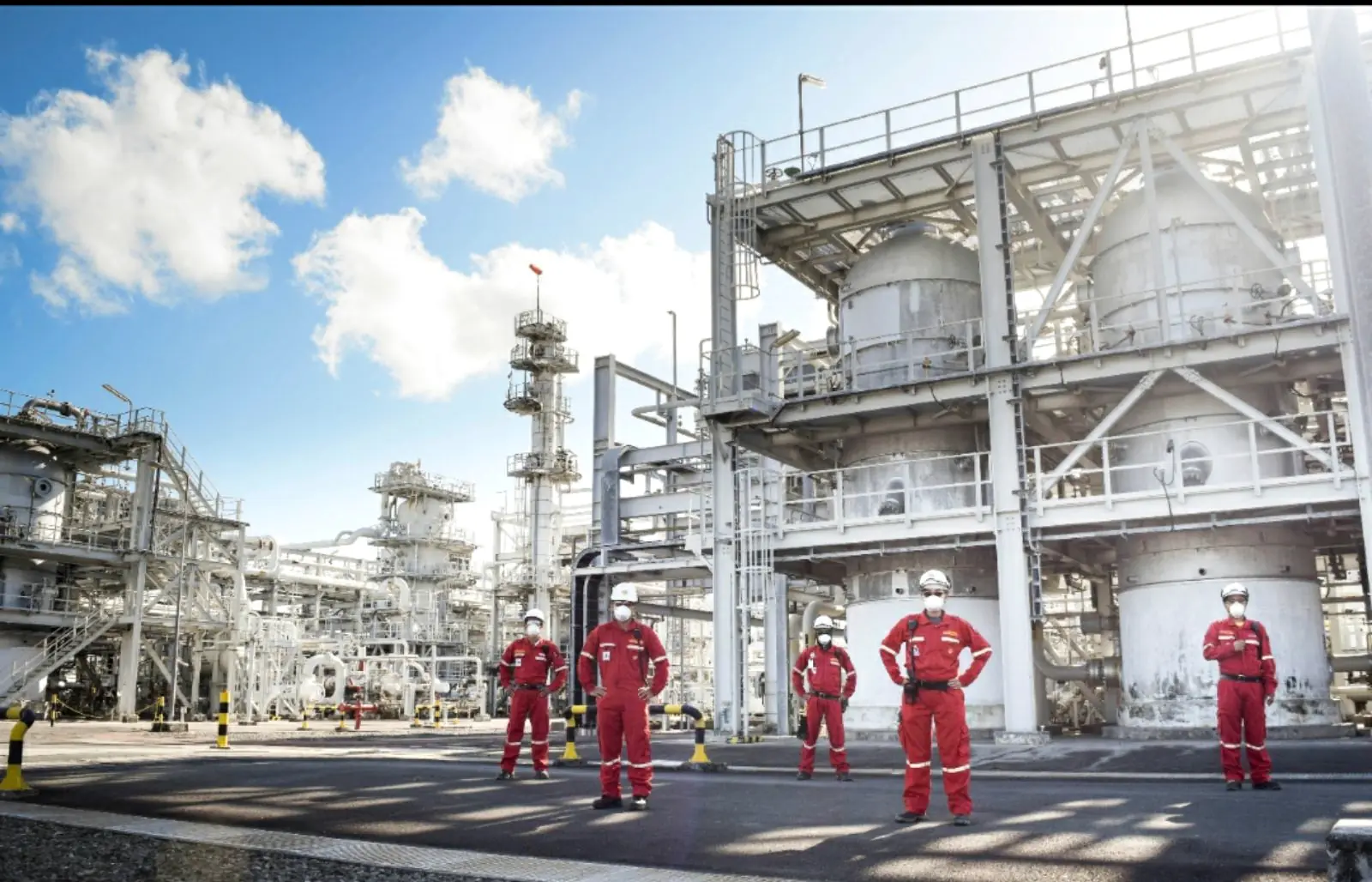 Process crew in coveralls at an onshore gas processing plant
